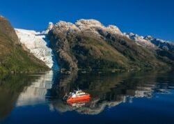 Catamaran in front of glacier